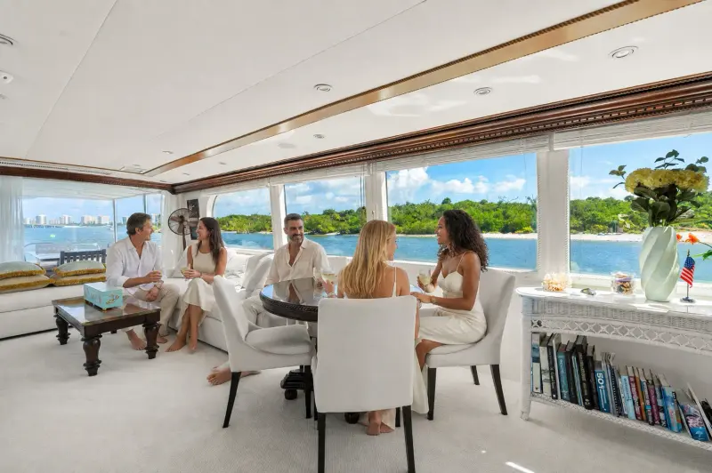 Friends in Bahama-white attire gathering in Envision's bright salon